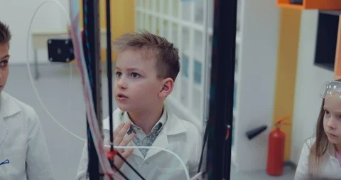 Schoolboy in a modern laboratory construct prototype with the help of 3D printer Stock Footage 86158674