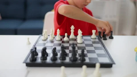 Schoolboy playing chess alone, improving concentration and critical thinking Stock Footage 224961084