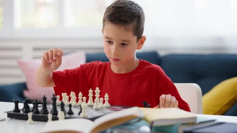 Schoolboy playing chess at home, improving memory, remembering combinations Stock Footage 230921888