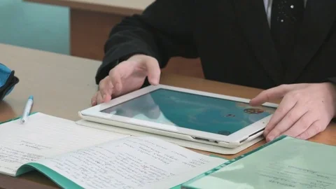 Schoolboy plays in games using computer tablet Stock Footage