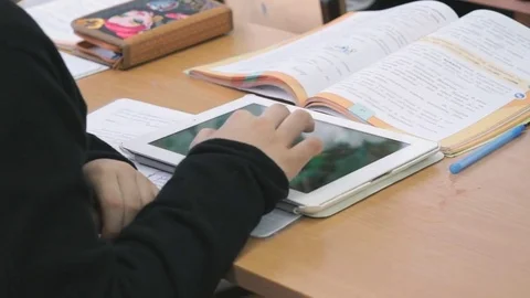 Schoolboy plays in games using computer tablet Stock Footage