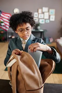 Schoolboy preparing for school at home Stock Photos