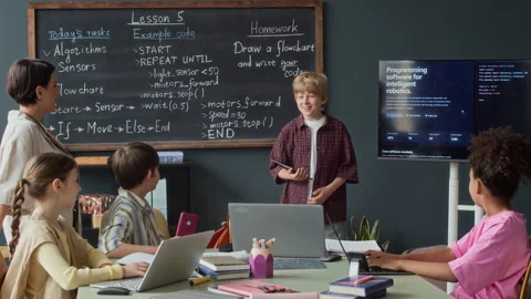 Schoolboy Presenting Robotics Lesson to Multiethnic Classmates Stock Footage 339200025