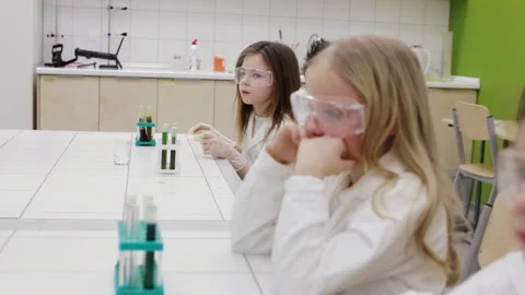 Schoolboy raising hand to answer the question in chemistry class Stock Footage 86930247