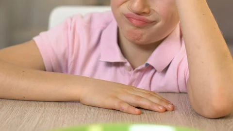 Schoolboy refusing to eat oatmeal, feeling disgust, healthy nutrition for kids 스톡 동영상 103807279