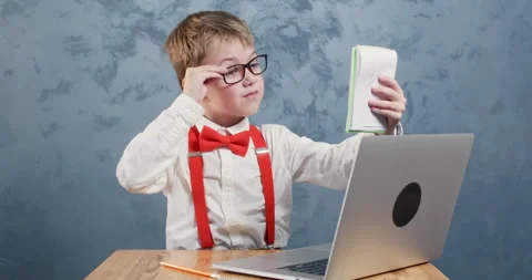 Schoolboy reviews notes in notebook making corrections Stockbeeldmateriaal 304366213