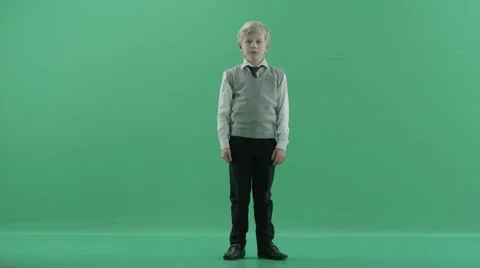 Schoolboy is showing thumbs down on green screen background Stock Footage 68844906