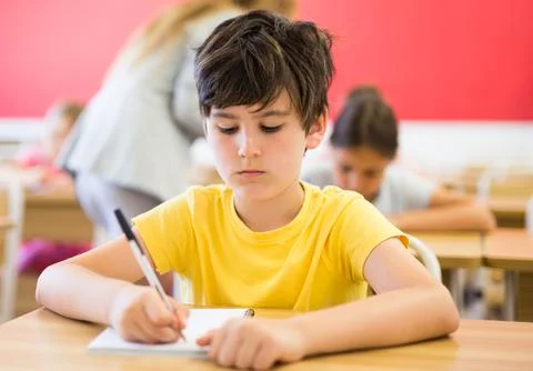 Schoolboy sitting in classroom during lesson in elementary school Stock Photos