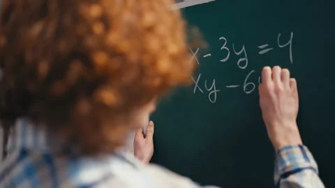 Schoolboy solving algebra equation on chalkboard, interested in mathematics Stock Footage 250319554