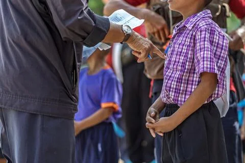 Schoolboy standing with referees checking documents. young schoolboy standi.. Photos