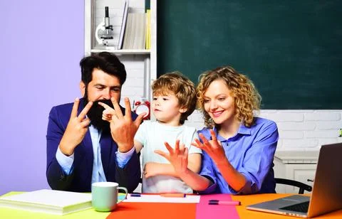 Schoolboy student doing math homework with tutors and learning to count on fi Foto stock