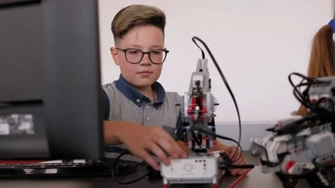 Schoolboy study in a robotics class, assemble a robot constructor. Stock Footage 142010337