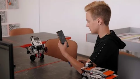 Schoolboy study in a robotics class, assemble a robot constructor. Stock Footage 142078657