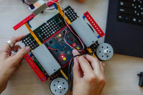 Schoolboy study in a robotics class, assemble a robot constructor. Stock Photos