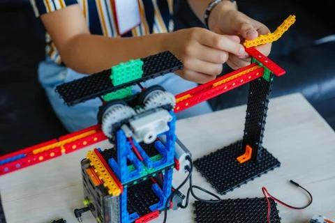 Schoolboy study in a robotics class, assemble a robot constructor. Stock Photos