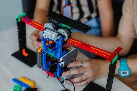 Schoolboy study in a robotics class, assemble a robot constructor. Stock Photos