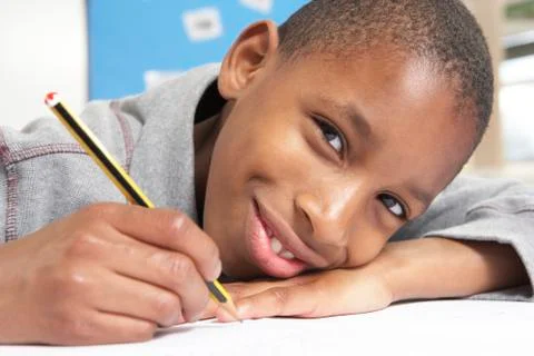 Schoolboy Studying In Classroom Stock Photos