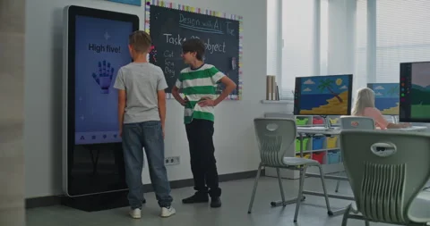 Schoolboy Uses Interactive Digital Screen, Talks Classmate. Boys Study STEM 動画素材 318078776