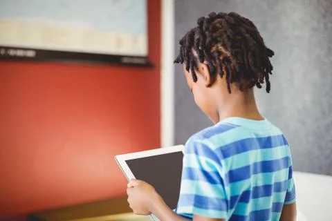 Schoolboy using digital tablet in classroom 스톡 사진