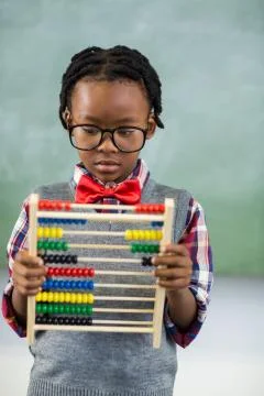 Schoolboy using a maths abacus in classroom Stock Photos