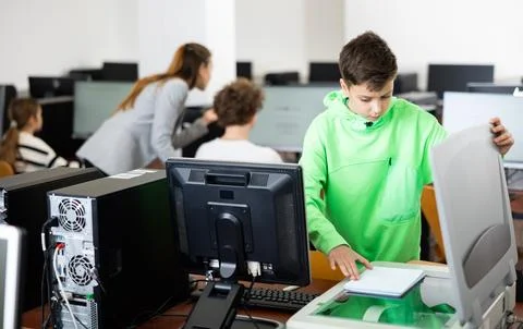 Schoolboy using printer during computer science lesson Stock Photos
