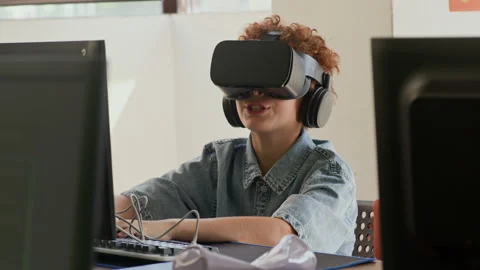Schoolboy with Virtual Reality Headset Commenting Immersive Experience Stock Footage 316477125