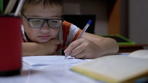 Schoolboy Writes with Left Hand in Notebook, Using Handle. Online Home Training Vidéo 142714914