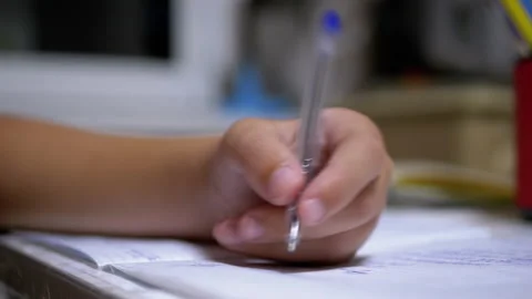 Schoolboy Writes with Left Hand in Notebook, Using Handle. Online Home Training Vidéo 143032990