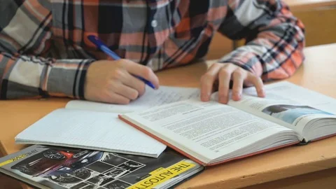 Schoolboy writes text in exercise book on lesson Stock Footage 70148500