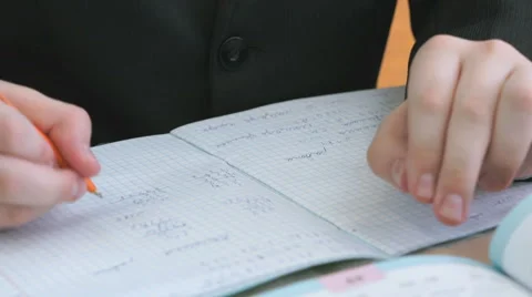 The schoolboy writing the text in the copybook Stock-Footage 69001261
