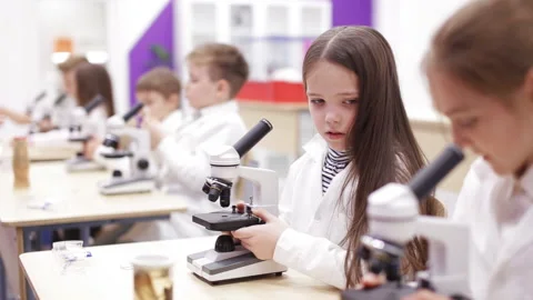 Schoolboys look through microscopes. Theme of modern education. 스톡 동영상 86798862