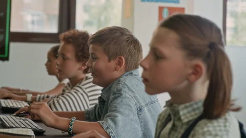 Schoolboys Looking at Computer Screens and Laughing at Programming Lesson Stock Footage 316479606