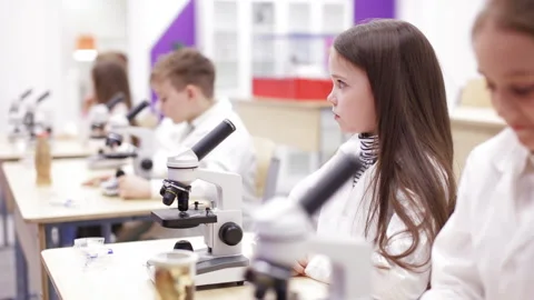 Schoolboys looking through microscope in laboratory Stock Footage 88853927