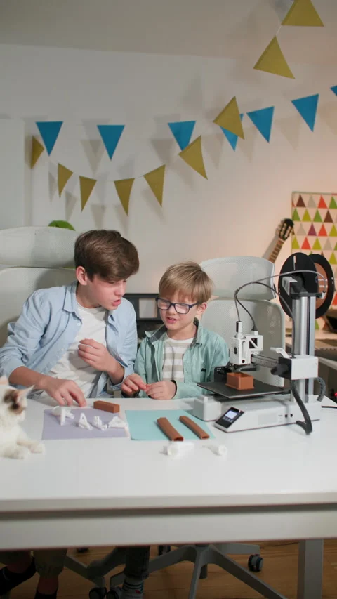 Schoolboys observe, chatting the operation of a 3D printer. They play with it Stock Footage 335391940
