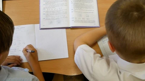 Schoolboys in Primary School Writes in  Notebook at the lesson Stock Footage 93889458