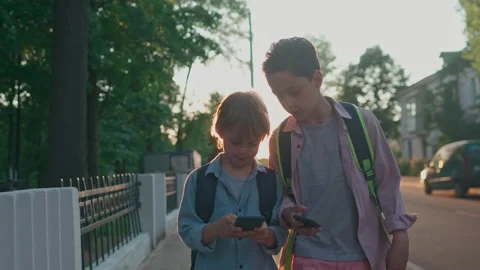 The schoolboys returning from school in a sunset time. Video stock 157822592