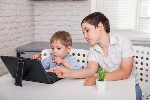 Schoolboys studies at home and does school homework. Stay at home. Fotos de archivo