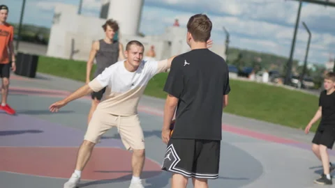 Schoolboys try to throw ball into hoop during game Vídeo Stock 326463142