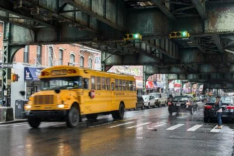  Schoolbus Yellow schoolbus driving through the rain underneith an elevate... Stock Photos
