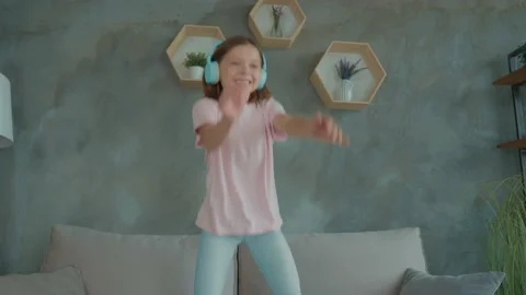 Schoolchild dance couch listen headset dream player rock stage in apartment Stock Footage 166678520