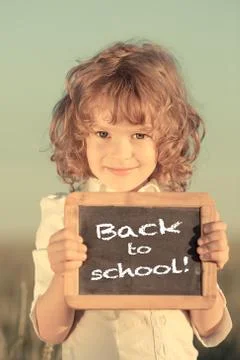 Schoolchild holding small blackboard Stock Photos