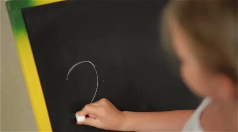 Schoolchild Practicing simple math on chalk board Stock Footage 64212647