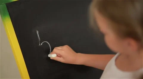 Schoolchild Practicing simple math on chalk board Stock Footage 64212817
