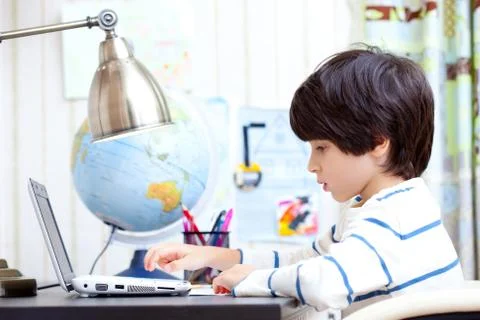 Schoolchild working on a computer Stock Photos