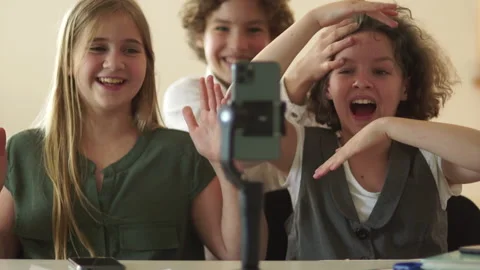 Schoolchildren and smartphone in class in school. Children and teenagers watch Stock Footage