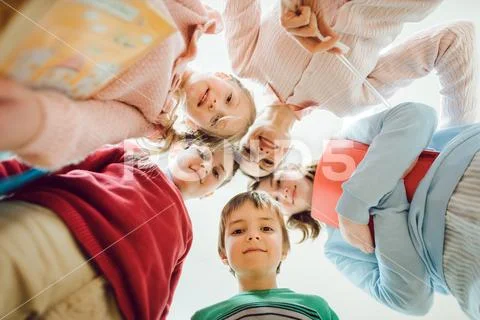 Schoolchildren and teacher looking down at the camera Stock Photos