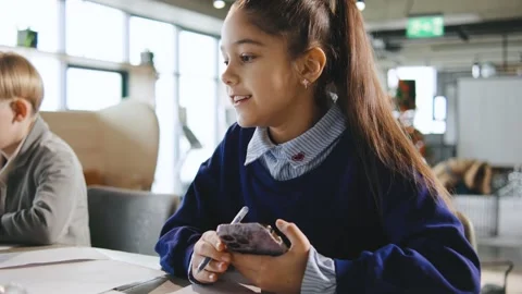 Schoolchildren are writing notes at a school activity in a classroom setting Stock Footage 331314690