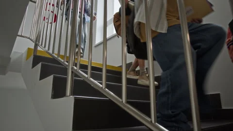 Schoolchildren with Backpacks Walking down Stairs at School Stock Footage 345221388