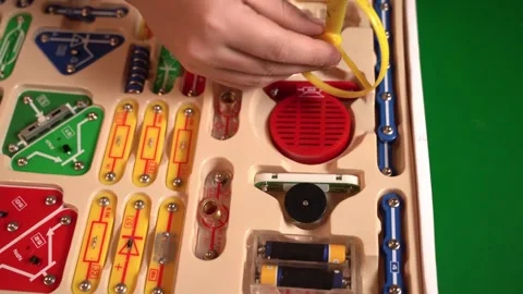 Schoolchildren build electric circuits using a hands-on construction kit Stock Footage 321087828