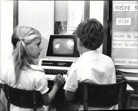 Schoolchildren Using Computers In The Classroom In The Early 1980's. Stock Photos